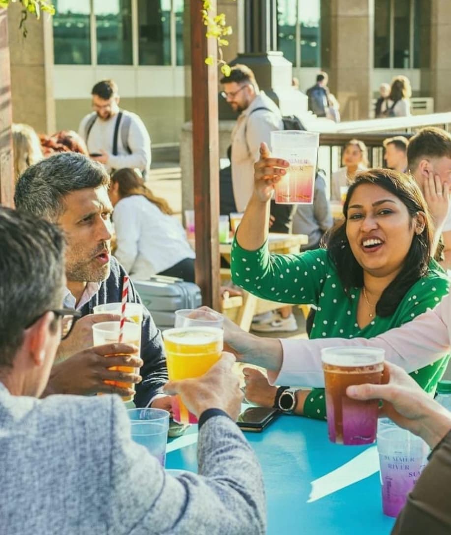 A group of people raising reusable cups together at an event
