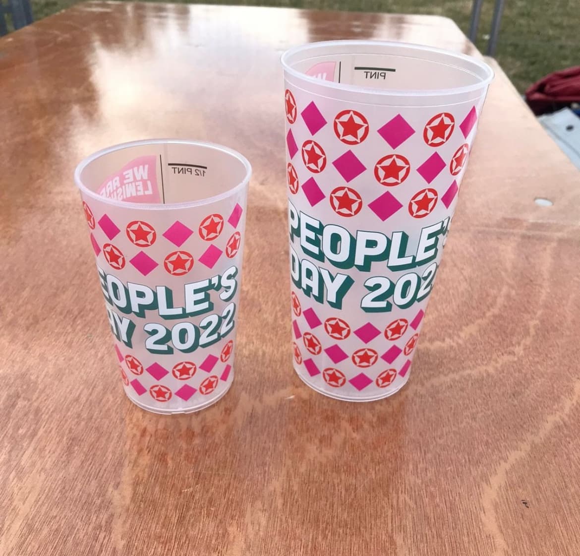 Two sizes of reusable cup printed with the same design